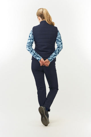 Pure Golf Eve reversible ladies gilet for golf is insulated, winter-weight, patterned and reversible. It has been Insulated for warmth without being bulky. One side features intricate Midnight Rose floral prints in navy and powder blue, while the other offers a classic plain navy option for versatility of wear. It has pockets on both sides and two-way zippers. The flattering quilting style and fit enhances your silhouette. 
