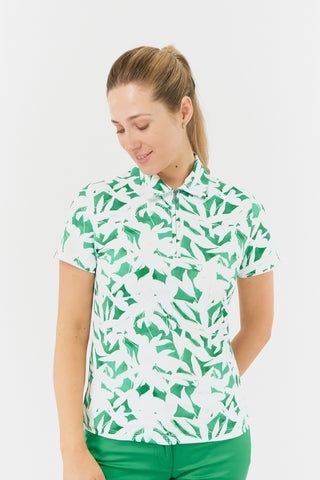 The Pure Golf Amity model front shot of the short sleeve ladies golf polo shirt with botanical print in emerald green and white. It is a regular fit and has a 4 way stretch which ensures it is comfortable and flattering for all body types. It boasts a traditional collar for a classic and stylish look. The polo shirt is anti-crease, anti-static and quick dry with UPF 50+ which is 95% Polyester and 5% Spandex. 