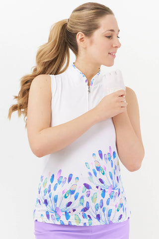 A woman wearing a sleeveless golf polo shirt with an opal wish dandelion-inspired print in jewel tones on a white background.