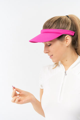 Hot Pink Clip ladies golf visor constructed with quick-drying fabrics. The visor comes in a one size fits all design which clips around your head to hold it securely in place. It also features a concealed magnet  in peak with a hand enamelled lace effect golf ball marker attached, making it a lovely golf accessory, golf gift! The headband features a soft lined absorbent towel. 