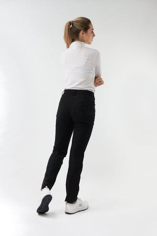 Black ladies golf trousers made from flexible lightweight 4 way stretch material.  Featuring a zip and button fastening with five belt loops, a regular fit with anti-crease and anti-static properties. These women's golf trousers have two open pockets to the front and back. Size 8 to 20.